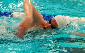 Swimmer performing a racing dive from the starting block