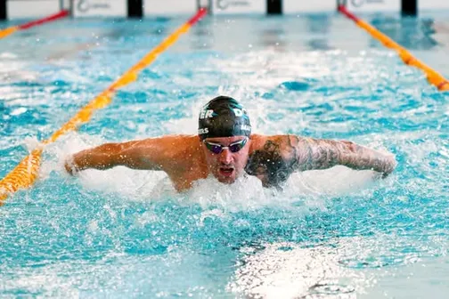 Swimmer performing butterfly stroke during a race